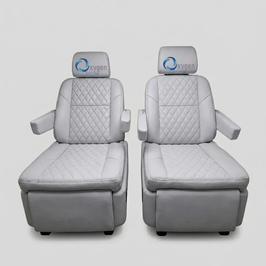 Premium light gray quilted leather captain's chairs reclined with footrests extended, showing electric reclining and footrest adjustment